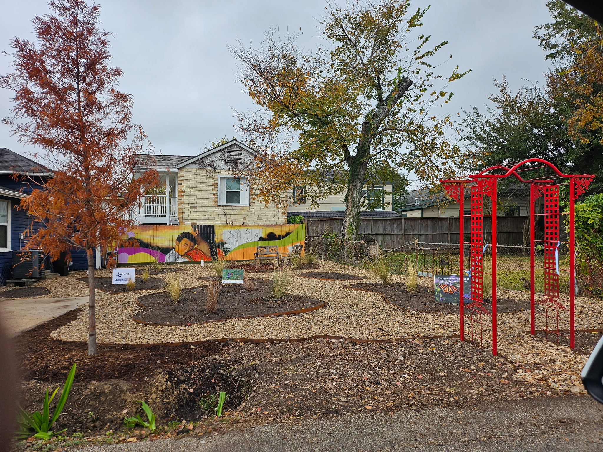 Community garden space with mural and native plantings